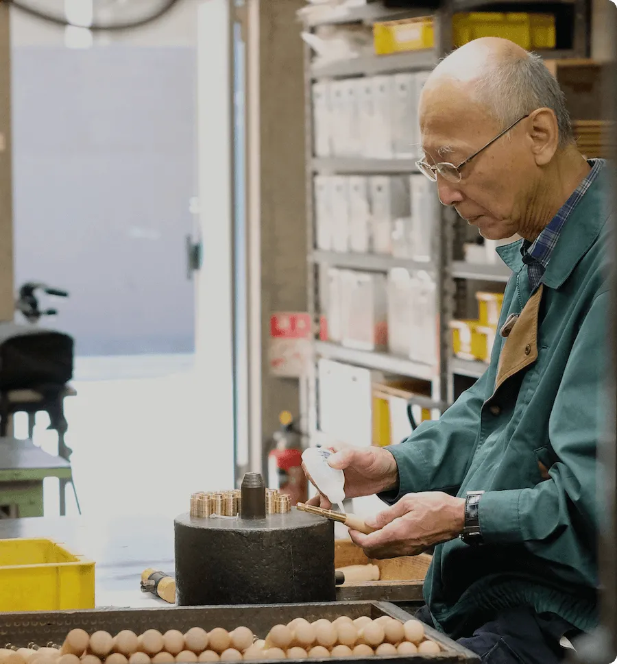 Kiyoshi Nonaka working at a bench in the Nonaka workshop